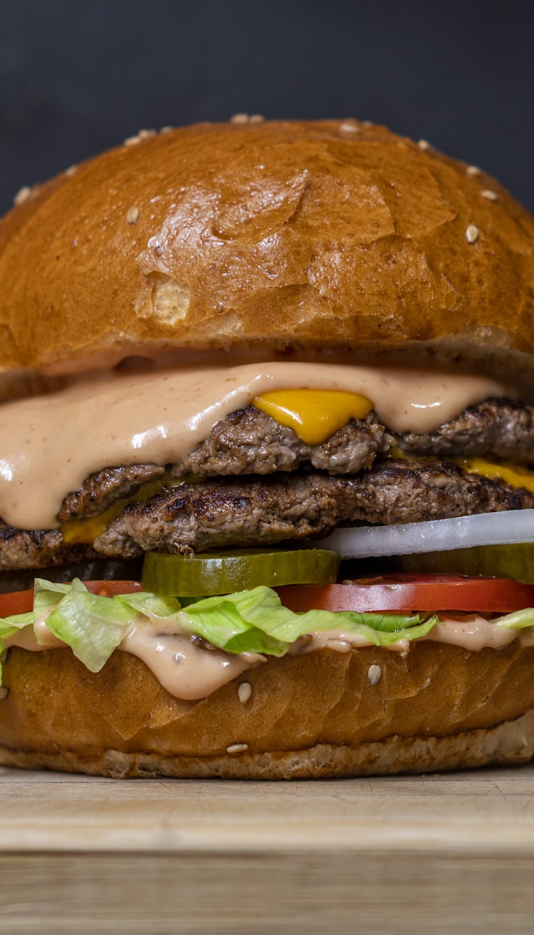 Vertical food video of a double cheeseburger, captioned for social